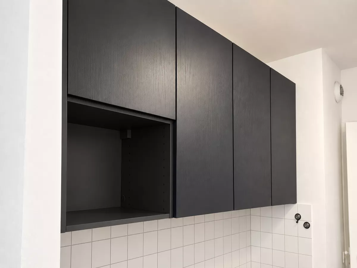 Meubles hauts noirs fixés au mur, réalisation sur mesure
